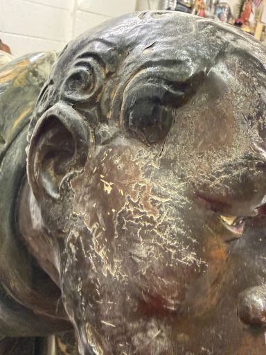 Despite surface damage, facial expression and details show. 